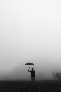 Man umbrella over foggy