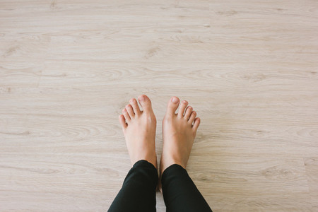 Selfie bare feet on wooden floor