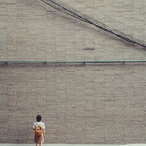 Young girl with brick wall