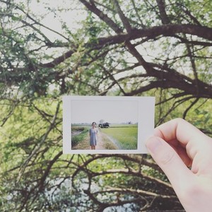Girl hand holding instant photo