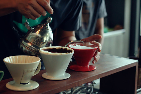 Barista brews a cups coffee