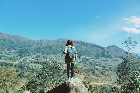 Young girl on top of mountain