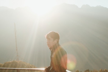 Young man standing with sunlight