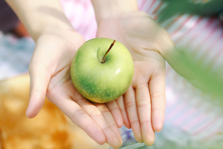 Green Apple in female hands