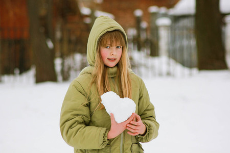 school girl with snow heart