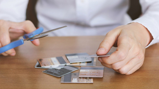 cutting credit card with scissor
