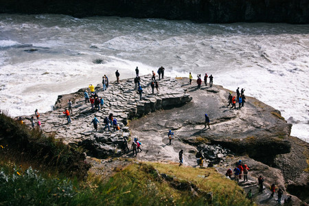 Gullfoss waterfall with people on rocks in Iceland