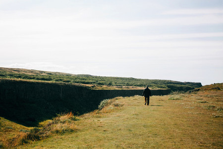 Alone man walking on the Icelandic landscape