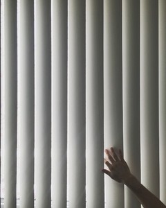 Hand touching blinds