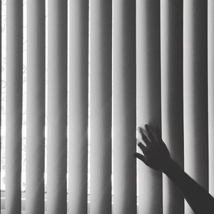 Hand touching blinds  BW