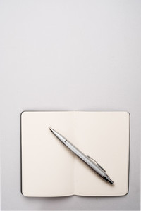 Blank open notebook with pen