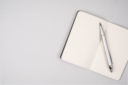 Blank open notebook with pen