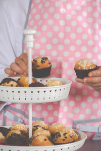 Girl placing muffins