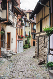 Street with half timbered medieval houses in Eguisheim village along the wine route  Alsace  France