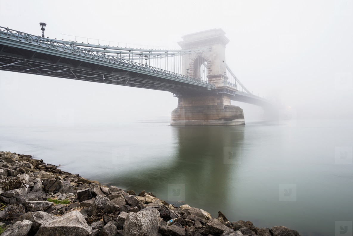 Chain Bridge over the Danube and a boat  Budapest  Hungary  in  fog  evening lights