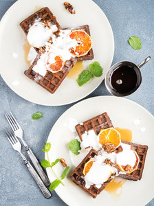 Belgian soft waffles with blood orange cream marple syrup and mint  on white plates