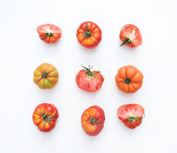 Selection of heirloom tomatoes on a white backdrop