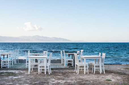 Chairs and tables in old cafe near the sea  Ciftlikkoy fishermen village  Aegean region  Turkey
