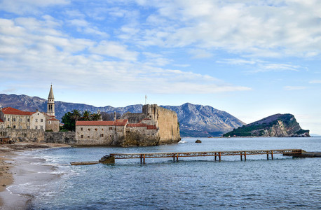 Budva  Montenegro  Beach near old town wall and fortress in wint