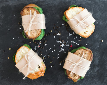 Chicken and spinach sandwiches wrapped in craft paper