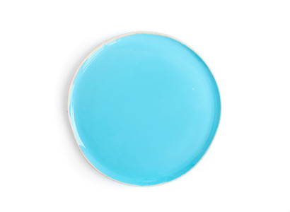 A round light blue glazed ceramic plate dish on a white backgr