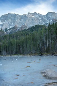 Frozen forest lake in Bavarian Alps near Eibsee lake  winter