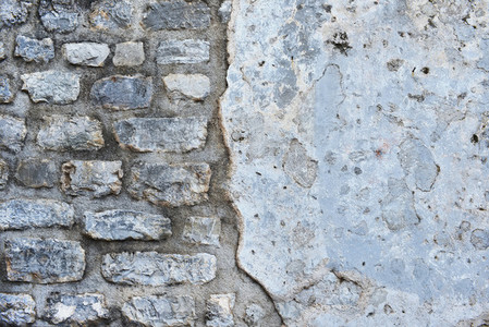 Old rough grey stone wall texture