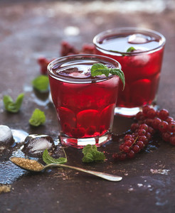 Red berry lemonade with ice and mint on grunge vintage rusty metal backdround