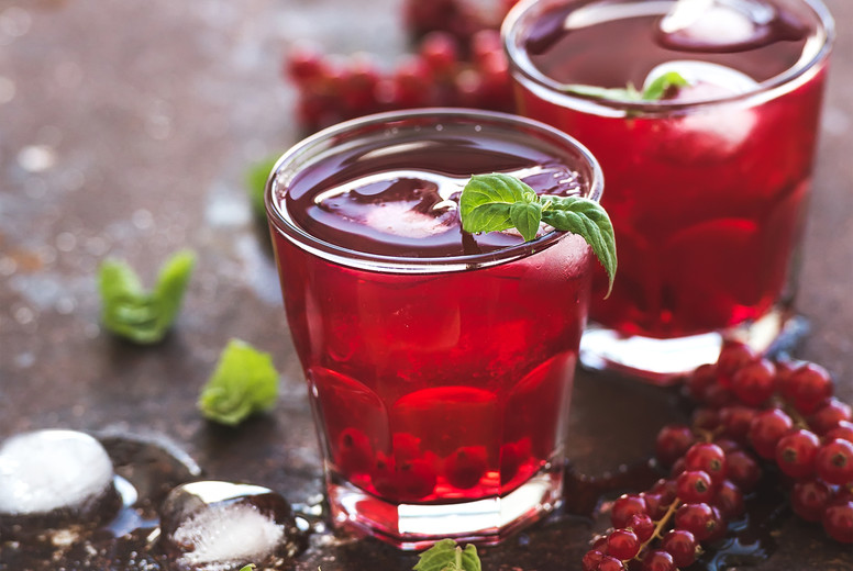 Red berry lemonade with ice and mint on grunge vintage rusty metal backdround.