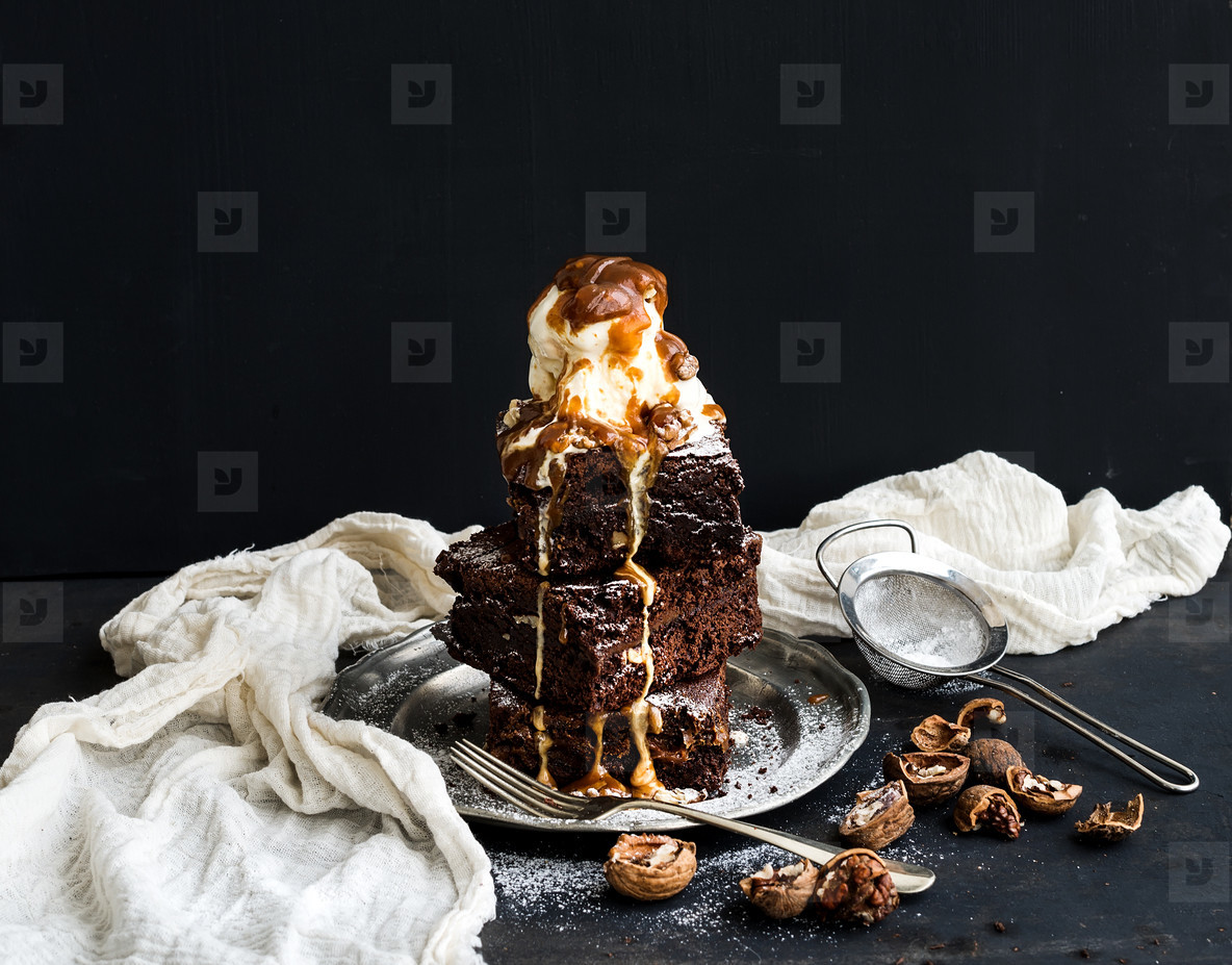 Fudgy Brownies tower with salted caramel, walnuts and ice-cream