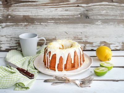 Moist lime and lemon bundt yoghurt cake  white rustic wooden  background