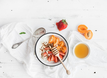 Healthy breakfast set  Rice cereal or porridge with fresh strawberry  apricots