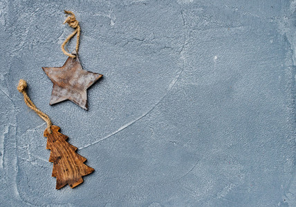 New year or Christmas background Toy rustic wooden star and fur tree over grunge grey surface top view
