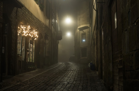 Old European narrow empty street of medieval town on a foggy evening  Taken in Bergamo  Citta Alta  Lombardia