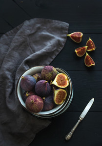 Rustic metal bowl of fresh figs on dark background  top view  selective focus
