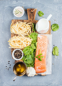 Ingredients for cooking pasta tagliatelle with salmon  spinach and cream