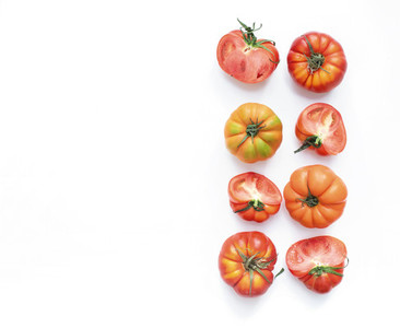Selection of heirloom tomatoes on a white backdrop