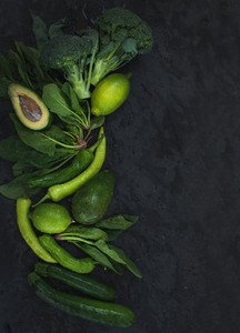 Raw green vegetables set  Broccoli  avocado  pepper  spinach  zuccini  lime on  dark stone background