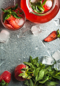Homemade strawberry lemonade with mint  ice and fresh berries over metal tray background  top view  copy space