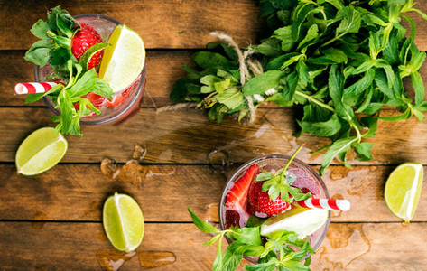 Strawberry mojito summer cocktails with mint and lime in glasses