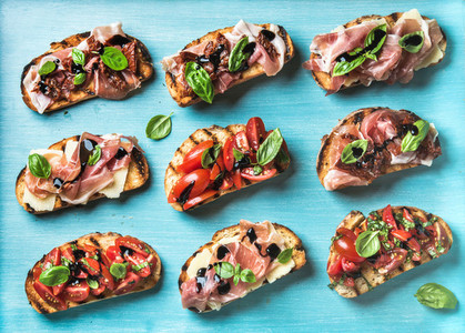 Brushetta snacks for wine Variety of small sandwiches on turquoise blue backdrop