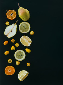 Fresh fruit andcitrus mix on black pieces of pear  mandarin  gr