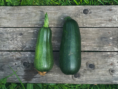 Green marrows on a wooden surface