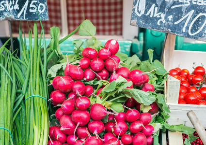 Garden radish and spring onions on a market stall
