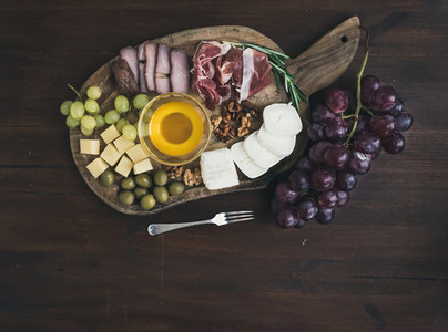 Wine appetizers set meat and cheese selection honey grapes w