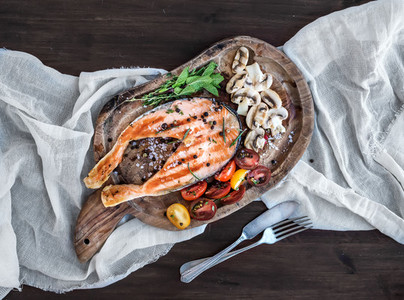 Grilled salmon steak with fresh herbs roasted mushrooms cherry