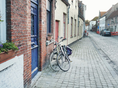 Medieval empty side street of Bruges  Belgium  with a bike parke