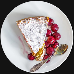 A piece of custard cherry pie on a white ceramic dessert plate