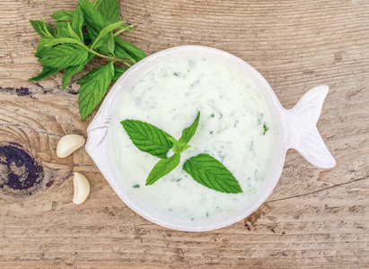 Cold summer yogurt and cucumber soup with fresh herbs