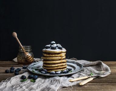Pancake tower with fresh blueberry and mint on a rustic metal plate